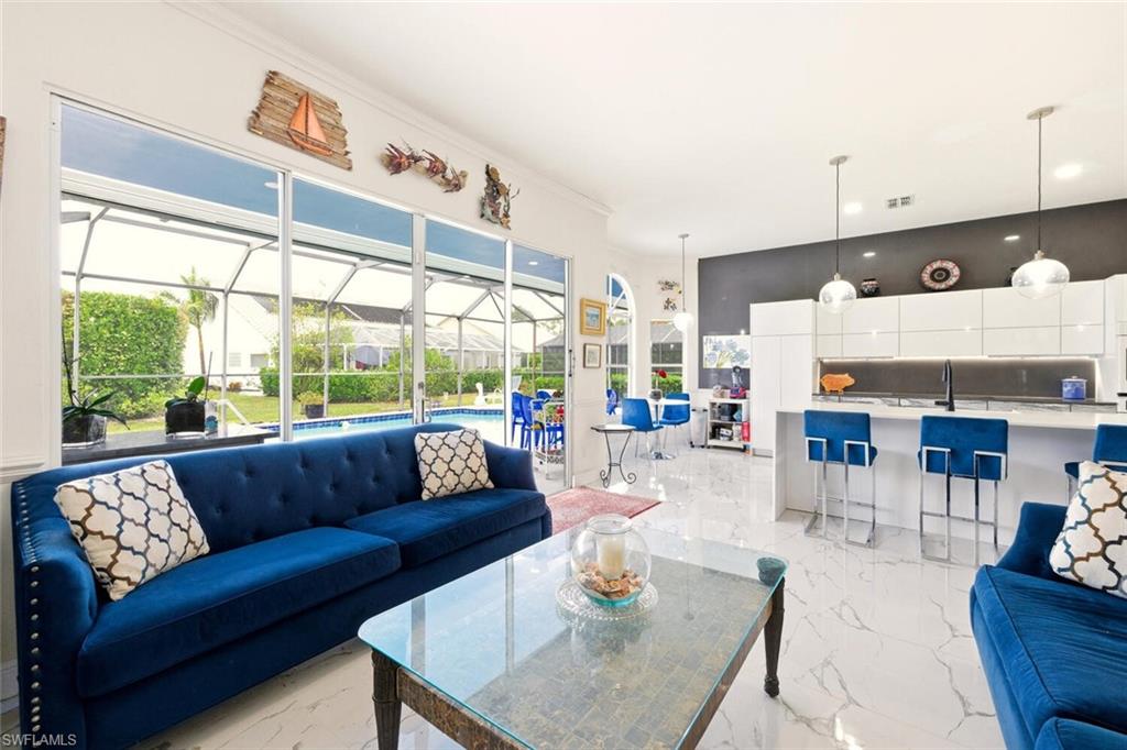 209 Countryside Drive Naples, FL 34104 - Photo 16 of 50 a living room with furniture and a large window