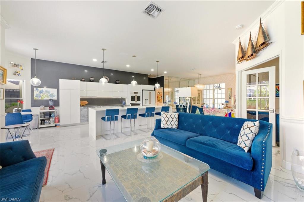209 Countryside Drive Naples, FL 34104 - Photo 17 of 50 a living room with furniture and a table