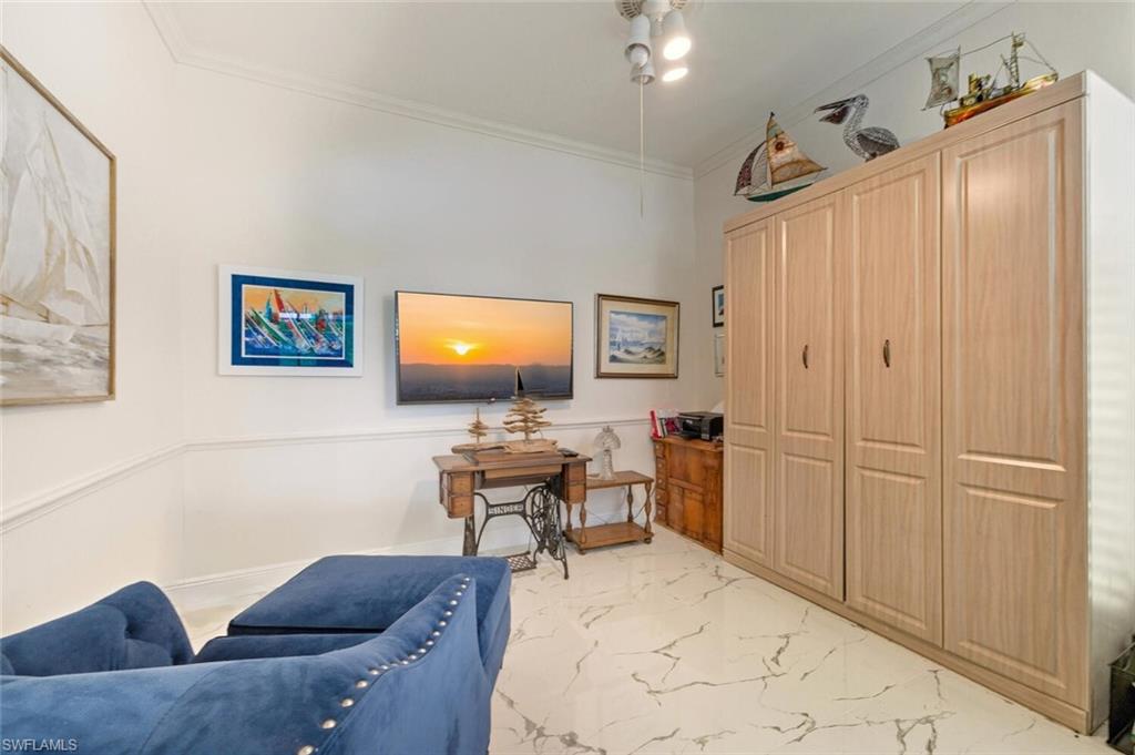 209 Countryside Drive Naples, FL 34104 - Photo 19 of 50 a living room with furniture a flat screen tv and a window