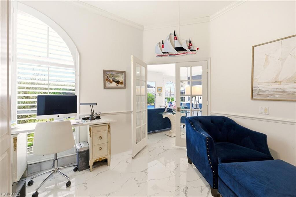 209 Countryside Drive Naples, FL 34104 - Photo 20 of 50 a living room with furniture and a flat screen tv