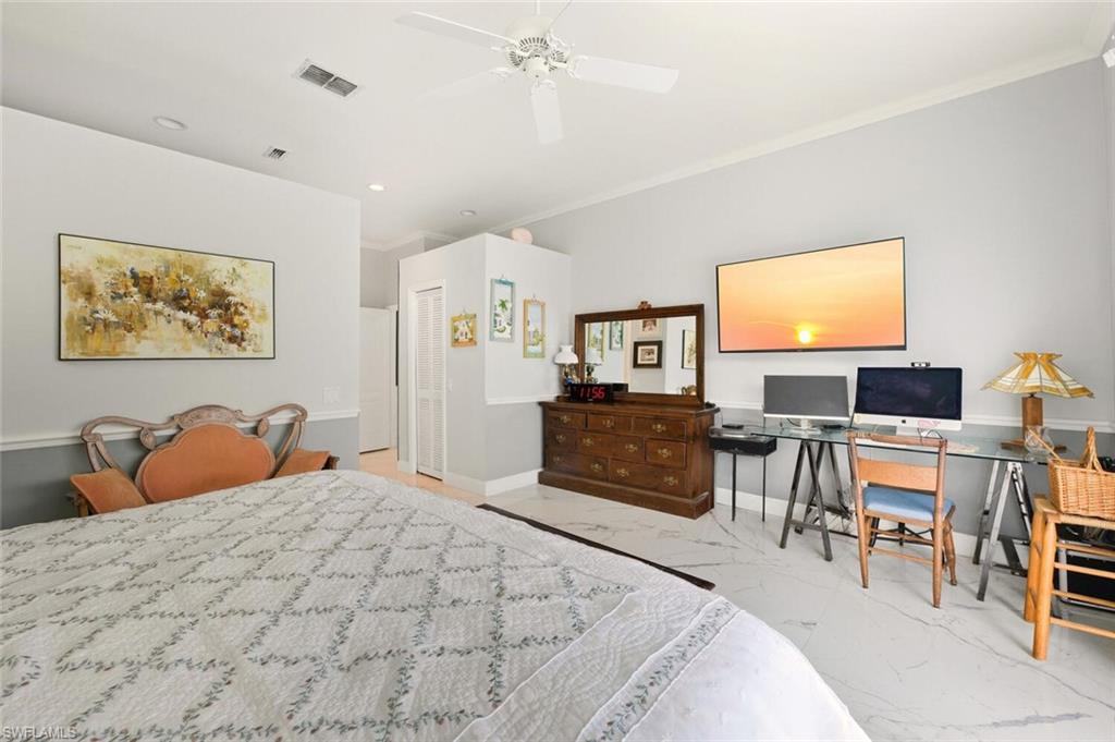 209 Countryside Drive Naples, FL 34104 - Photo 22 of 50 a bedroom with a bed and a flat screen tv