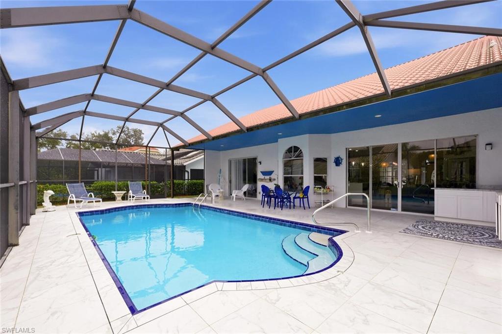 209 Countryside Drive Naples, FL 34104 - Photo 30 of 50 a view of a patio with swimming pool table and chairs