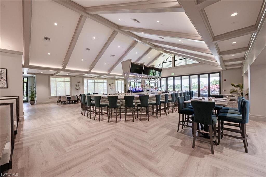 209 Countryside Drive Naples, FL 34104 - Photo 43 of 50 a dining hall with lots of furniture a large window and stainless steel appliances