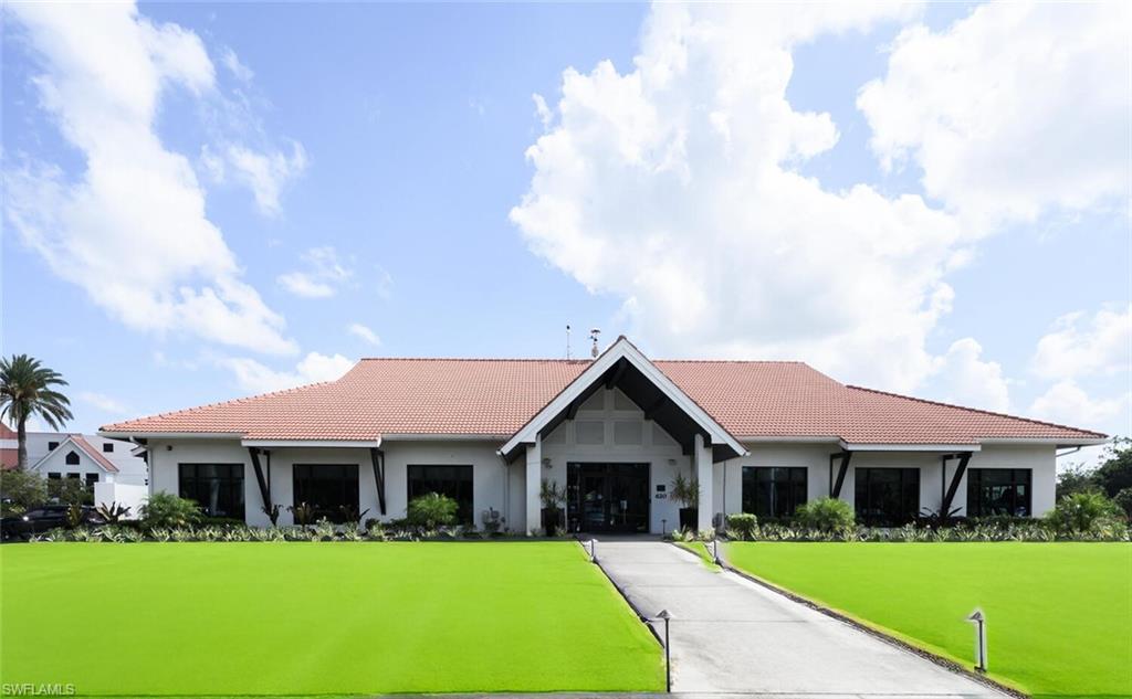 209 Countryside Drive Naples, FL 34104 - Photo 45 of 50 a front view of house with yard and green space