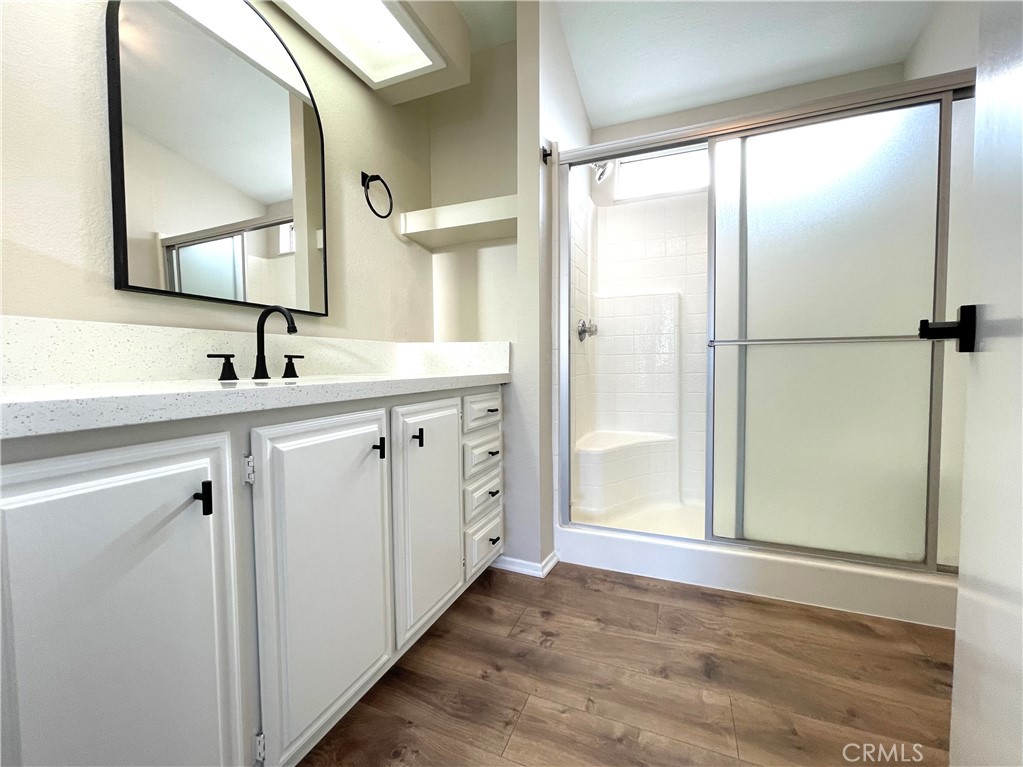 12546 Navajo Road Apple Valley, CA 92308 - Photo 3 of 27 Primary bedroom en suite bathroom with modern finishes and lots of storage.