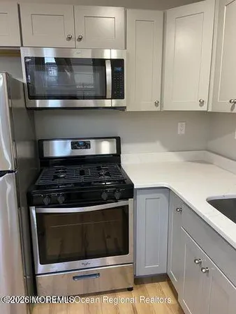 a stove top oven sitting inside of a kitchen