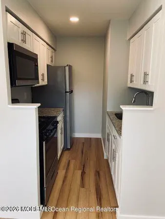 a view of a kitchen with electric appliances