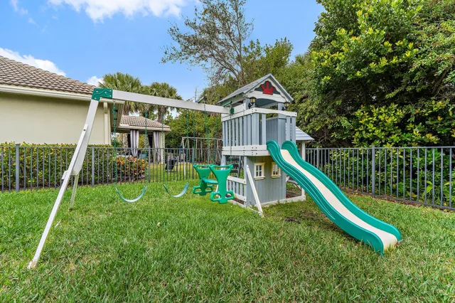 a kitchen with kitchen island granite countertop stainless steel appliances a sink a stove a refrigerator cabinets and a center island