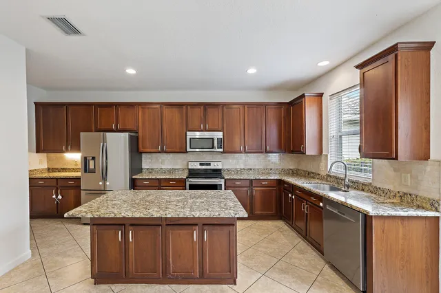 an empty room with wooden floor and mirror