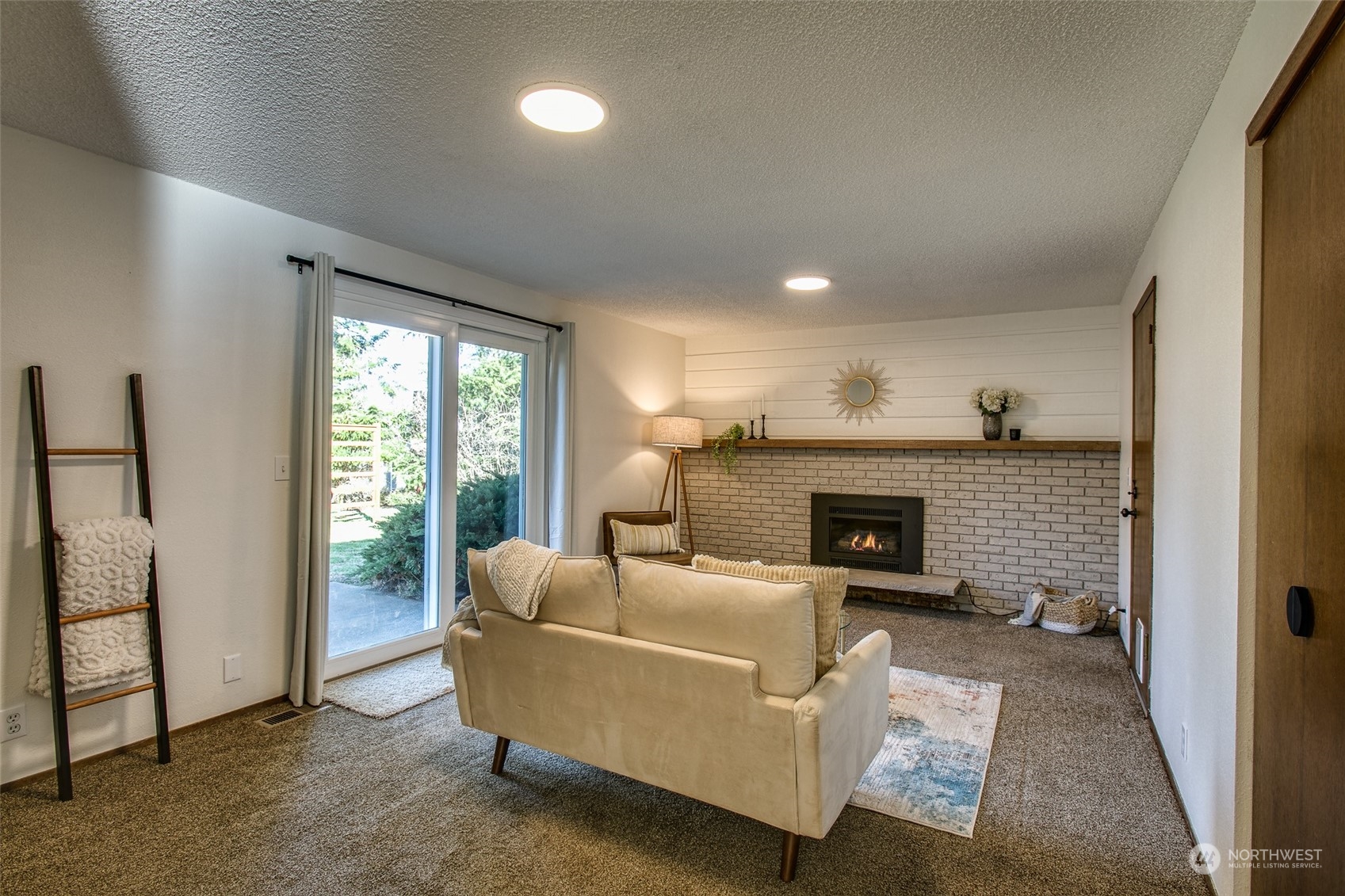 514 Cypress Road Bellingham, WA 98225 - Photo 11 of 31 a living room with furniture and a fireplace