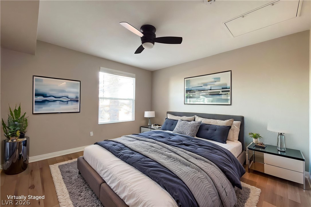 8101 West Flamingo Road, Unit 2131 Las Vegas, NV 89147 - Photo 4 of 13 Well-lit sleeping quarters with rich wood flooring and a modern ceiling fan.