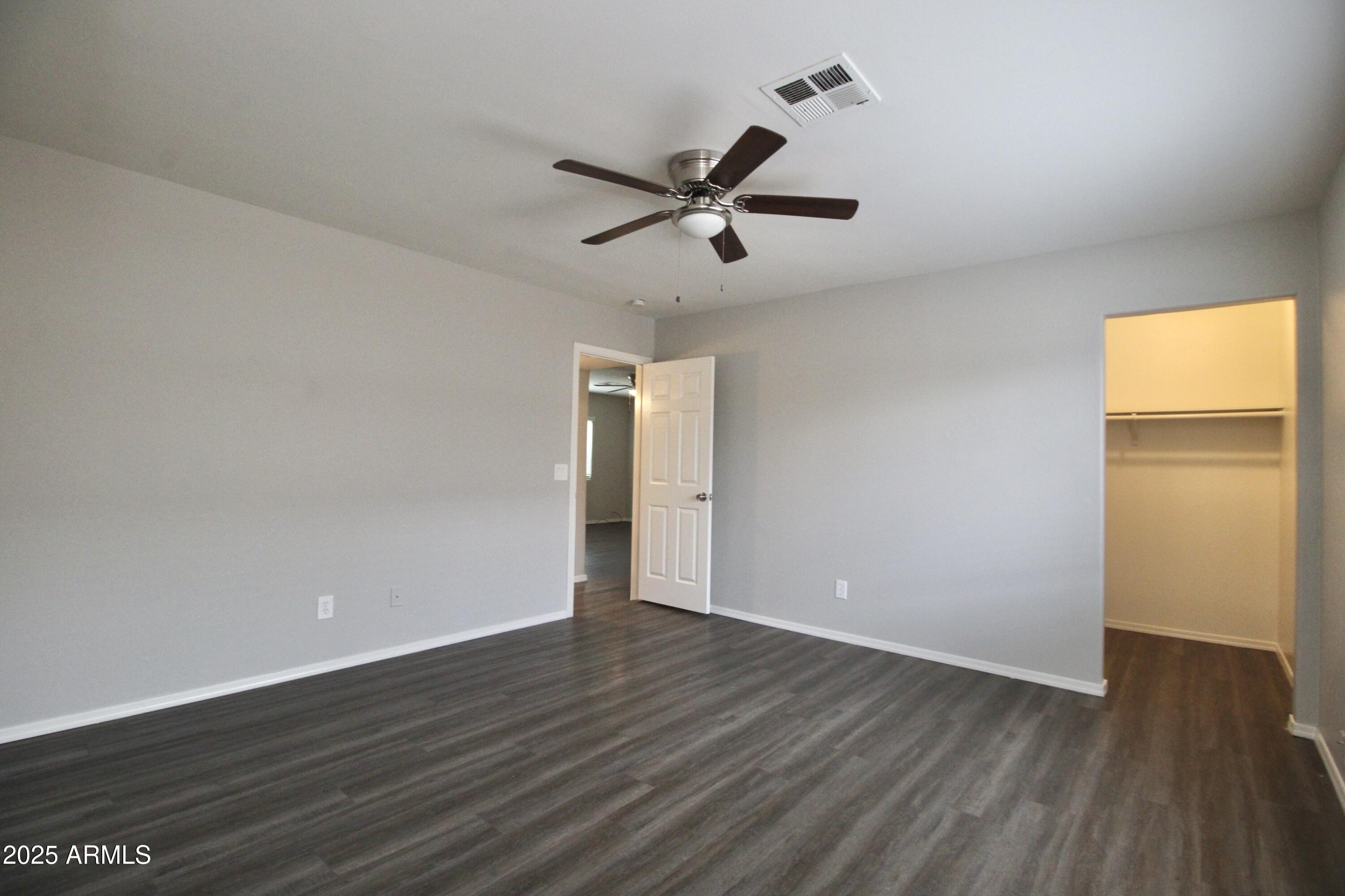 1732 West Maricopa Street, Unit 1 Phoenix, AZ 85007 - Photo 12 of 30 an empty room with wooden floor and windows