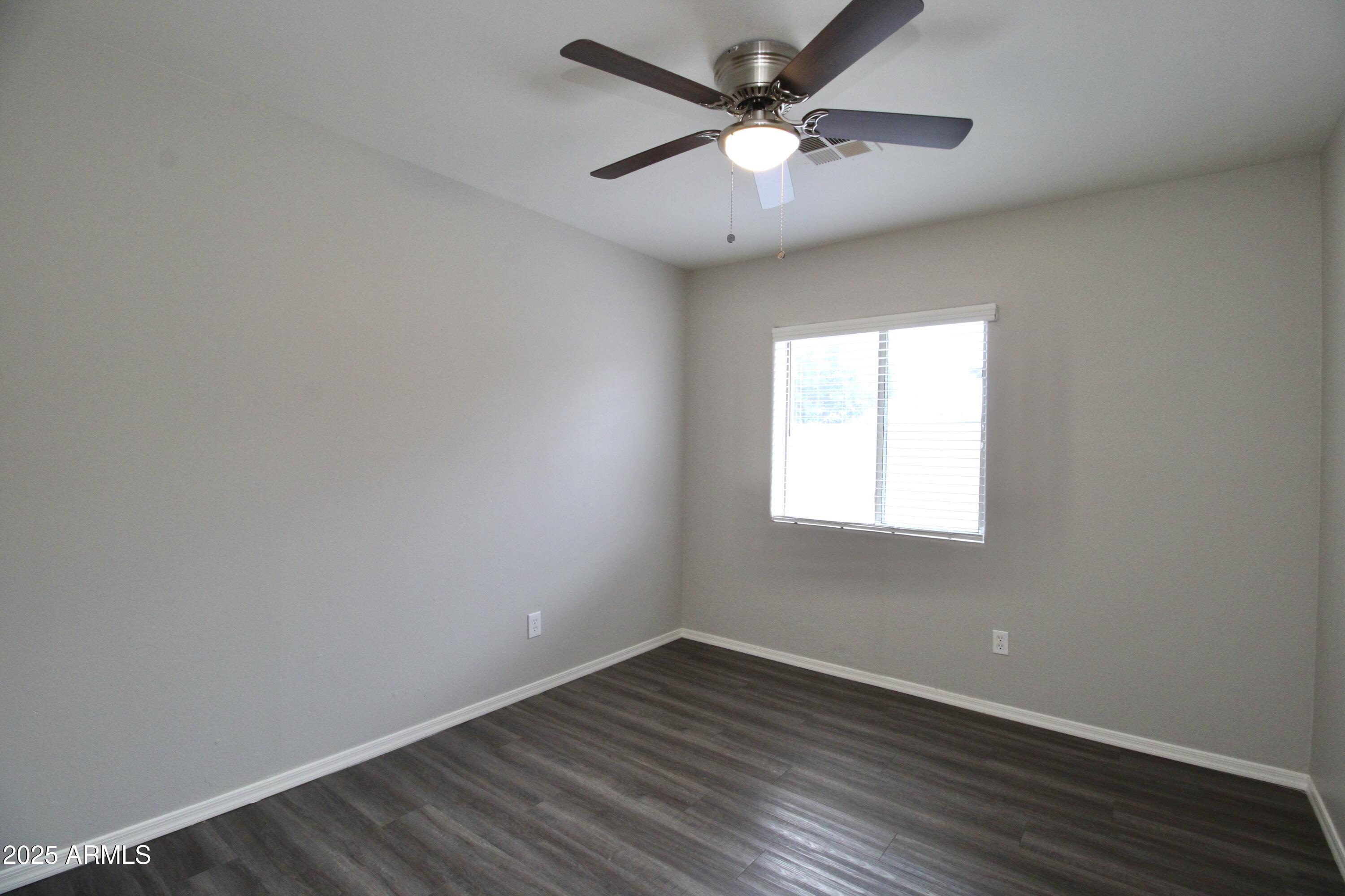 1732 West Maricopa Street, Unit 1 Phoenix, AZ 85007 - Photo 14 of 30 an empty room with wooden floor and windows
