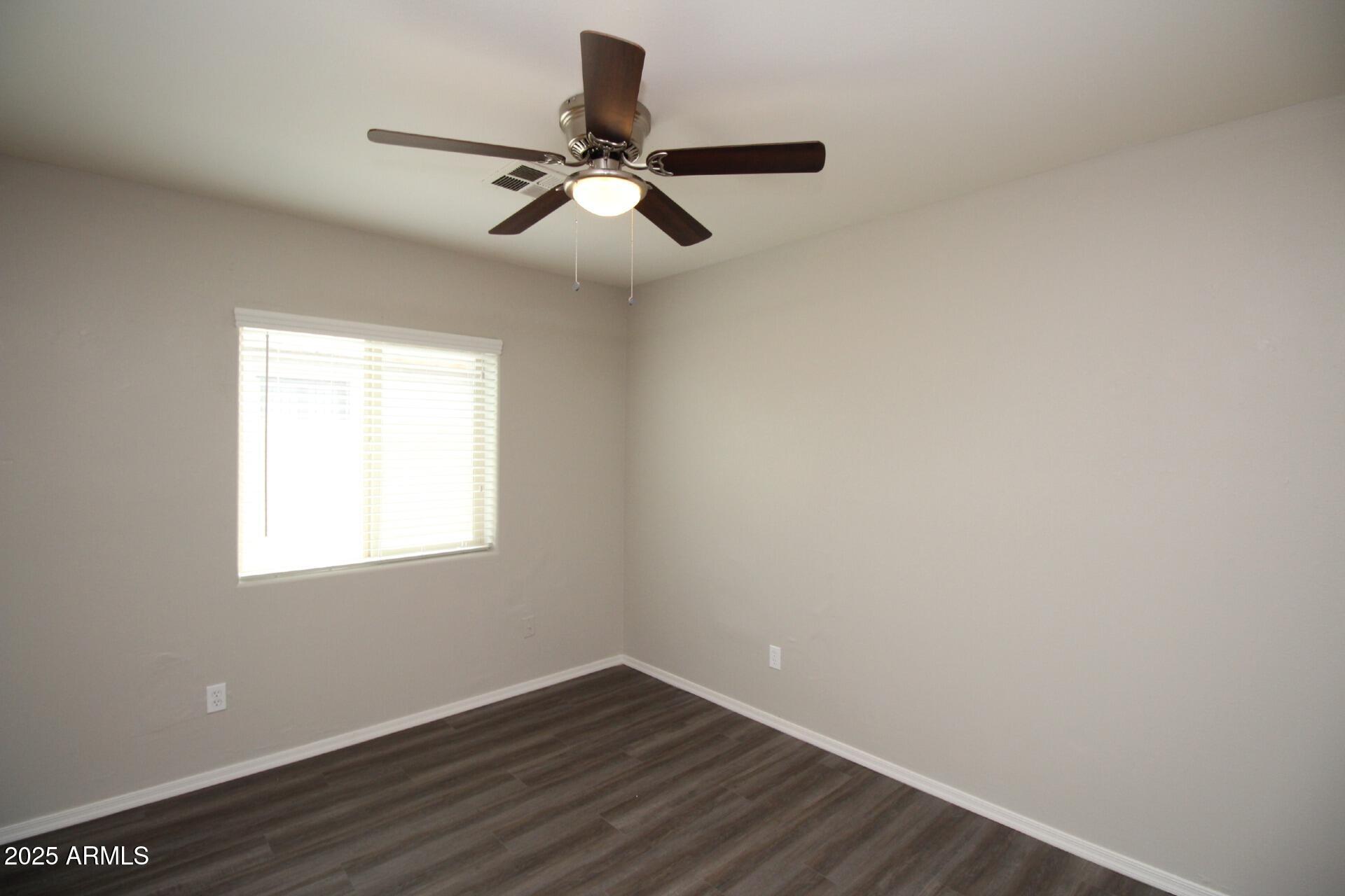 1732 West Maricopa Street, Unit 1 Phoenix, AZ 85007 - Photo 17 of 30 a view of a room with wooden floor closet and windows