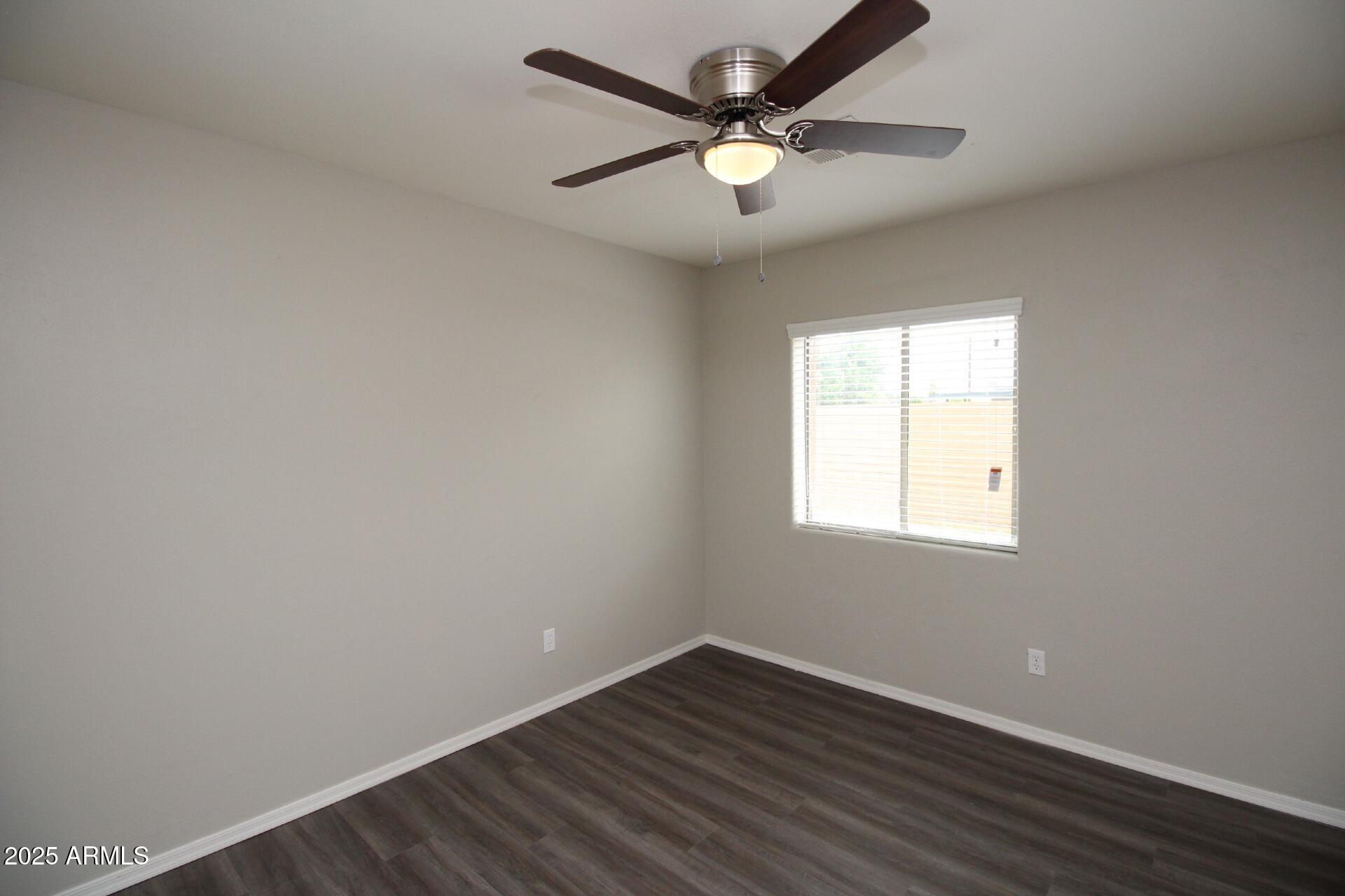 1732 West Maricopa Street, Unit 1 Phoenix, AZ 85007 - Photo 21 of 30 an empty room with wooden floor and windows
