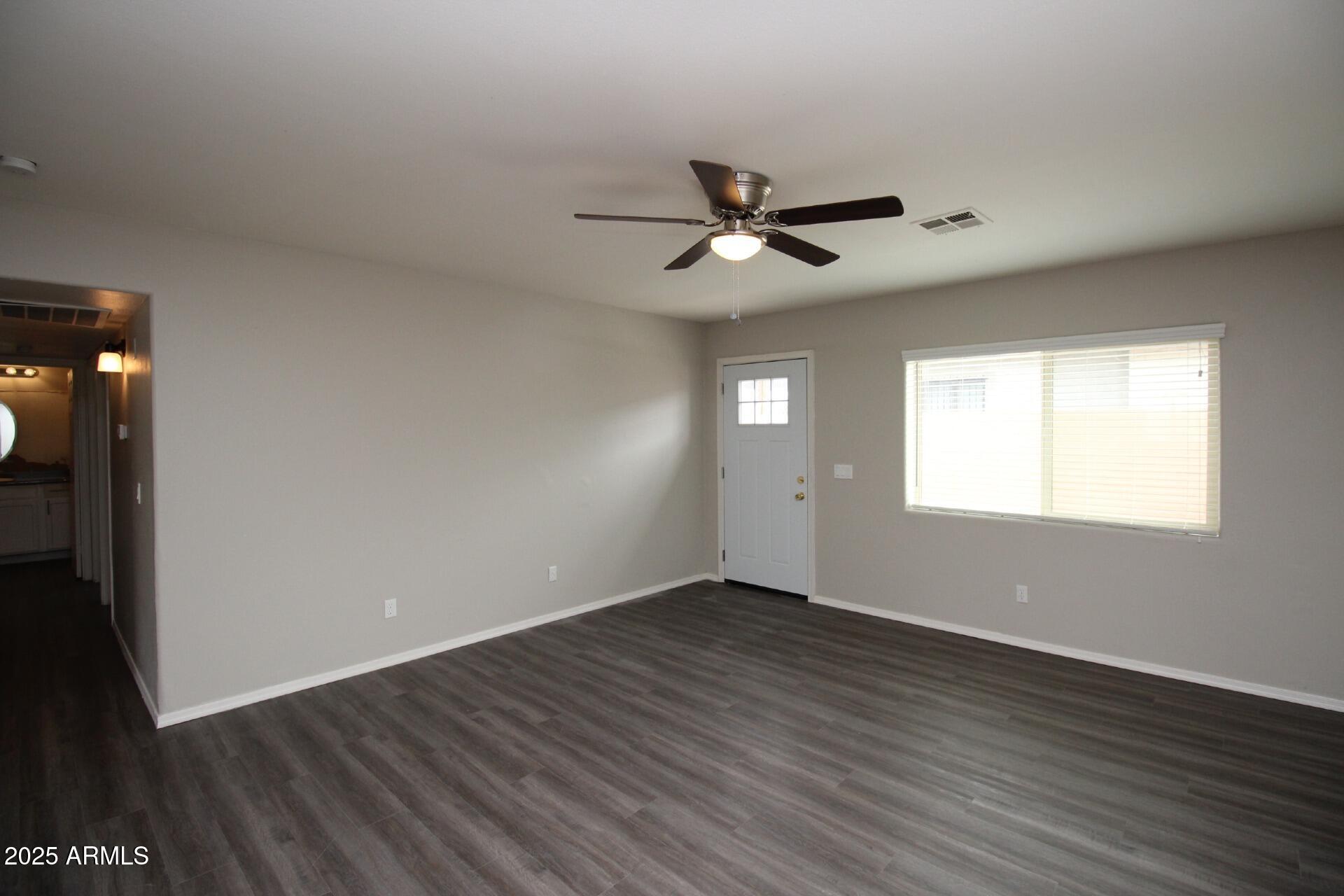 1732 West Maricopa Street, Unit 1 Phoenix, AZ 85007 - Photo 6 of 30 a view of empty room with wooden floor and fan