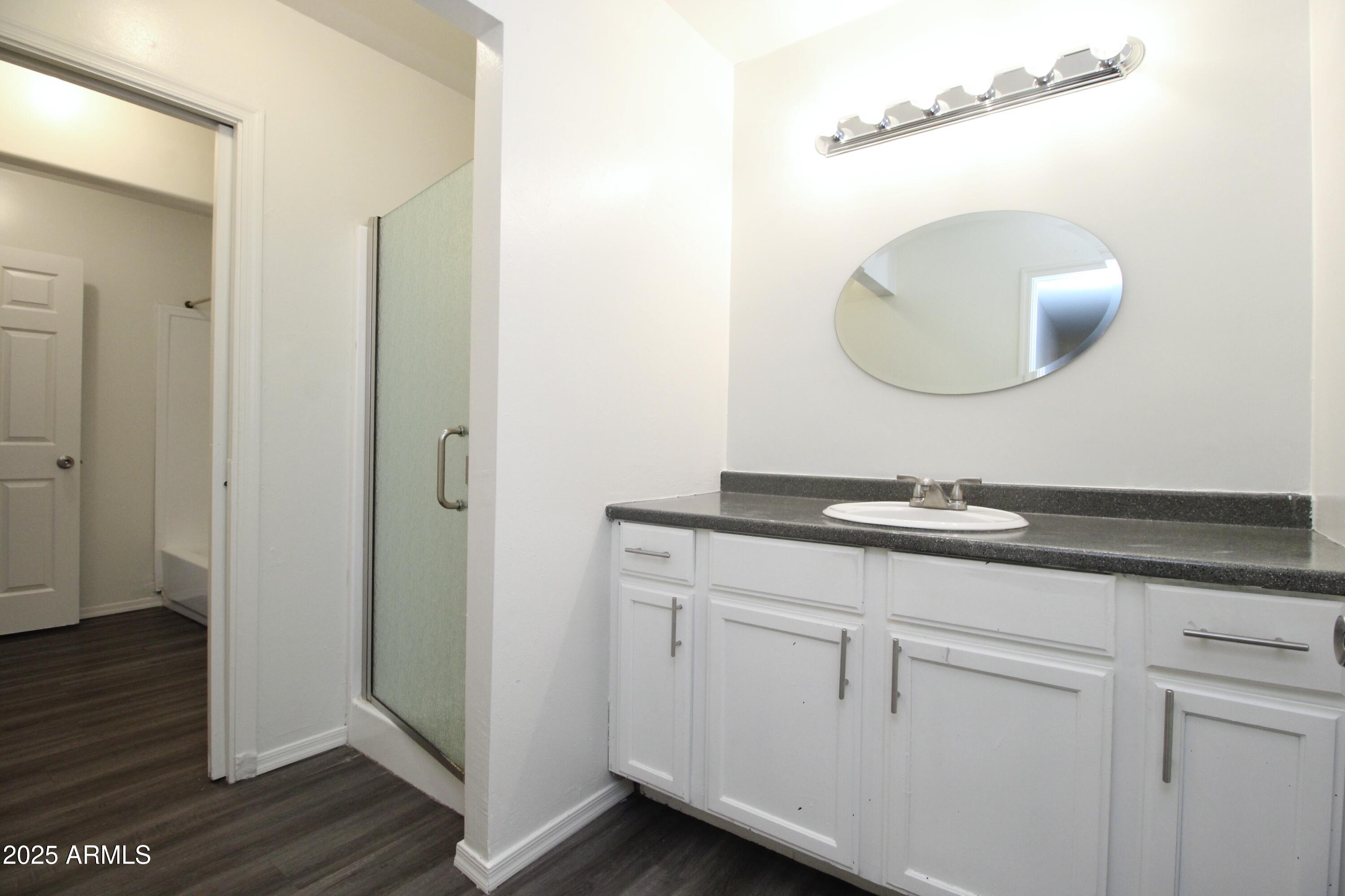 1732 West Maricopa Street, Unit 1 Phoenix, AZ 85007 - Photo 9 of 30 a bathroom with a double vanity sink and mirror
