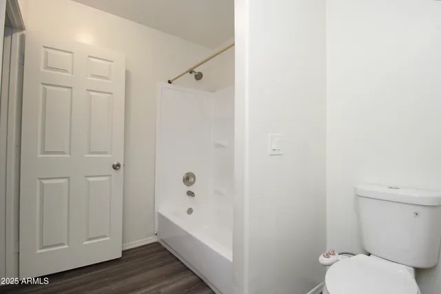 a bathroom with a granite countertop bathtub and toilet