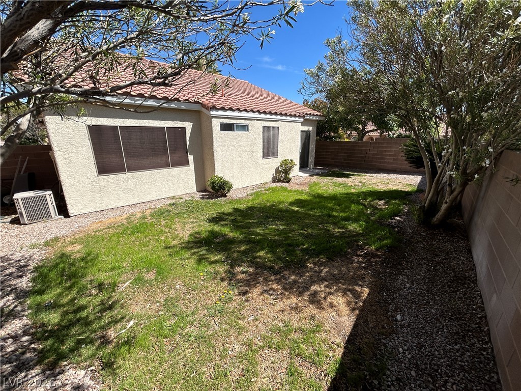1840 Montvale Las Vegas, NV 89134 - Photo 30 of 31 A modest rear yard offers a blend of natural landscaping and partial fencing.