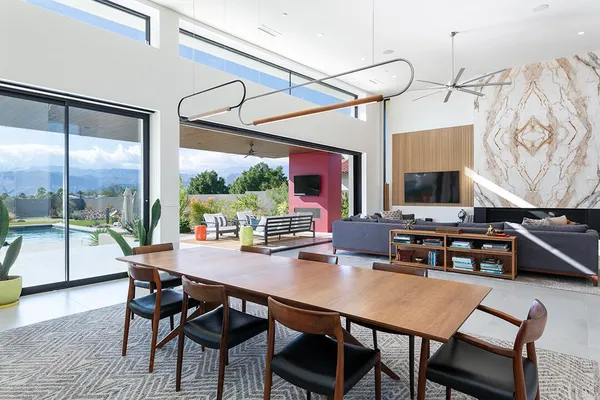 a kitchen with stainless steel appliances granite countertop a table chairs sink and cabinets