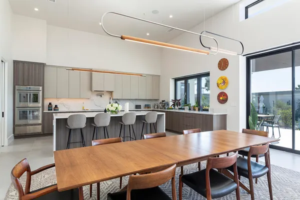 a kitchen with stainless steel appliances a stove a sink and white cabinets