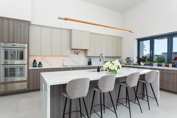 a large kitchen with stainless steel appliances granite countertop a sink and a large window