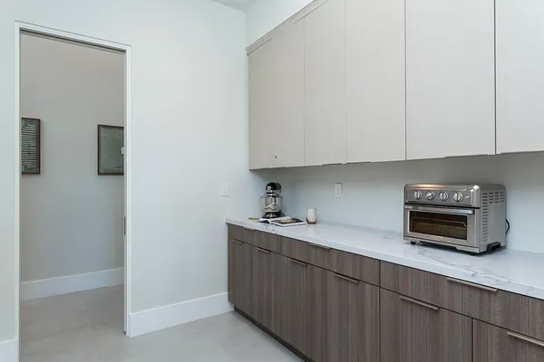 a view of a patio with table and chairs potted plants with wooden floor and fence