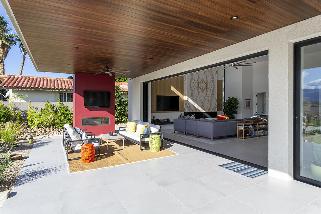 72145 Vía Vail Rancho Mirage, CA 92270 - Photo 19 of 68 a view of a patio with table and chairs potted plants with wooden floor and fence