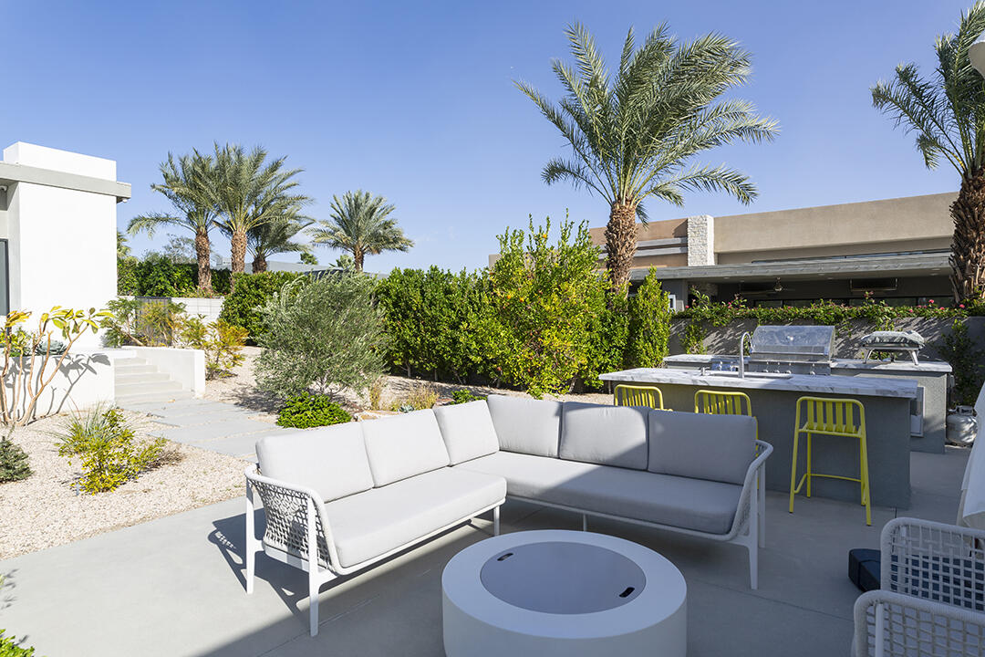72145 Vía Vail Rancho Mirage, CA 92270 - Photo 23 of 68 a view of a patio with couches and a potted plant on a table and chair