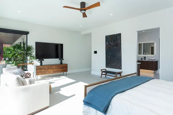 a dining hall with stainless steel appliances a table and chairs