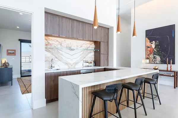 a bathroom with a granite countertop sink and a toilet