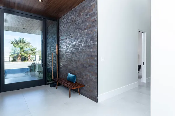 a bedroom with furniture and a large window