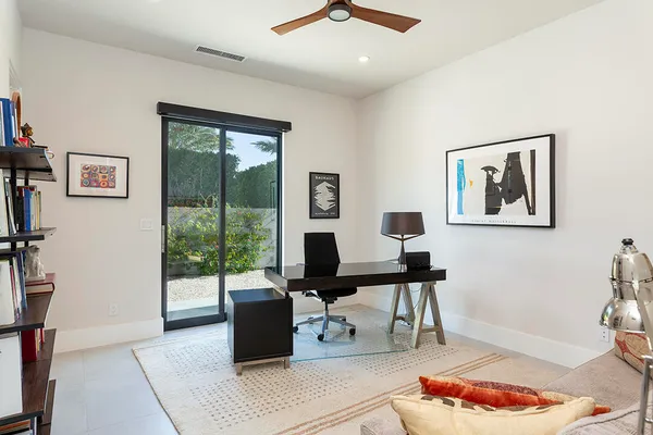 a living room with furniture and a floor to ceiling window