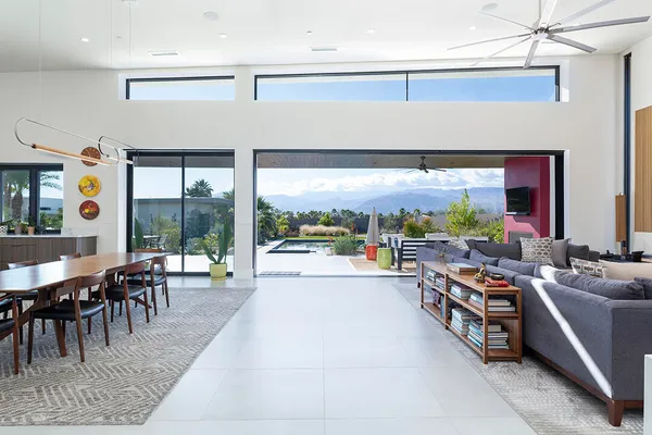 a living room with patio furniture and a flat screen tv