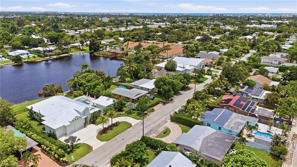 1316 Rordon Avenue Naples, FL 34103 - Photo 3 of 38 Expansive property featuring waterfront access, a private swimming pool, and lush landscaping