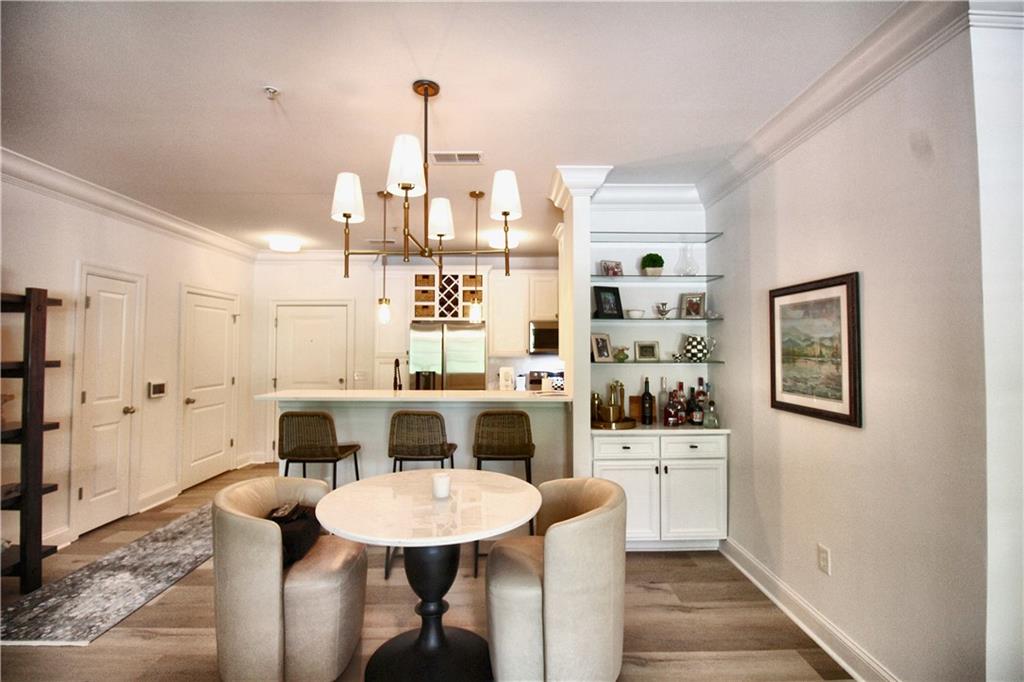 901 Abernathy Road Northeast, Unit 2110 Sandy Springs, GA 30328 - Photo 2 of 29 a view of a dining room with furniture and wooden floor