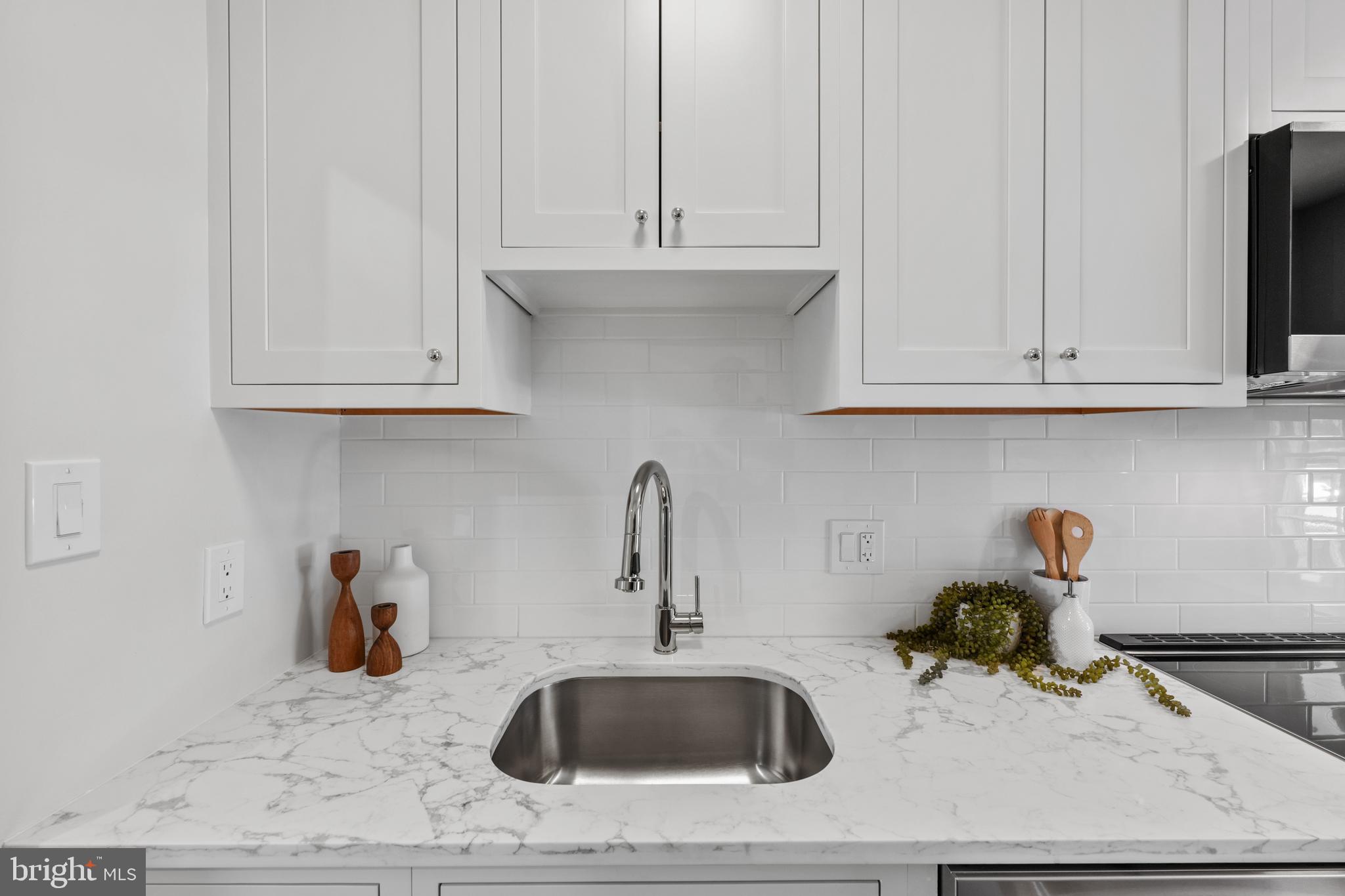 3265 Sutton Place Northwest, Unit B Washington, DC 20016 - Photo 11 of 45 a kitchen with stainless steel appliances granite countertop white cabinets and a sink