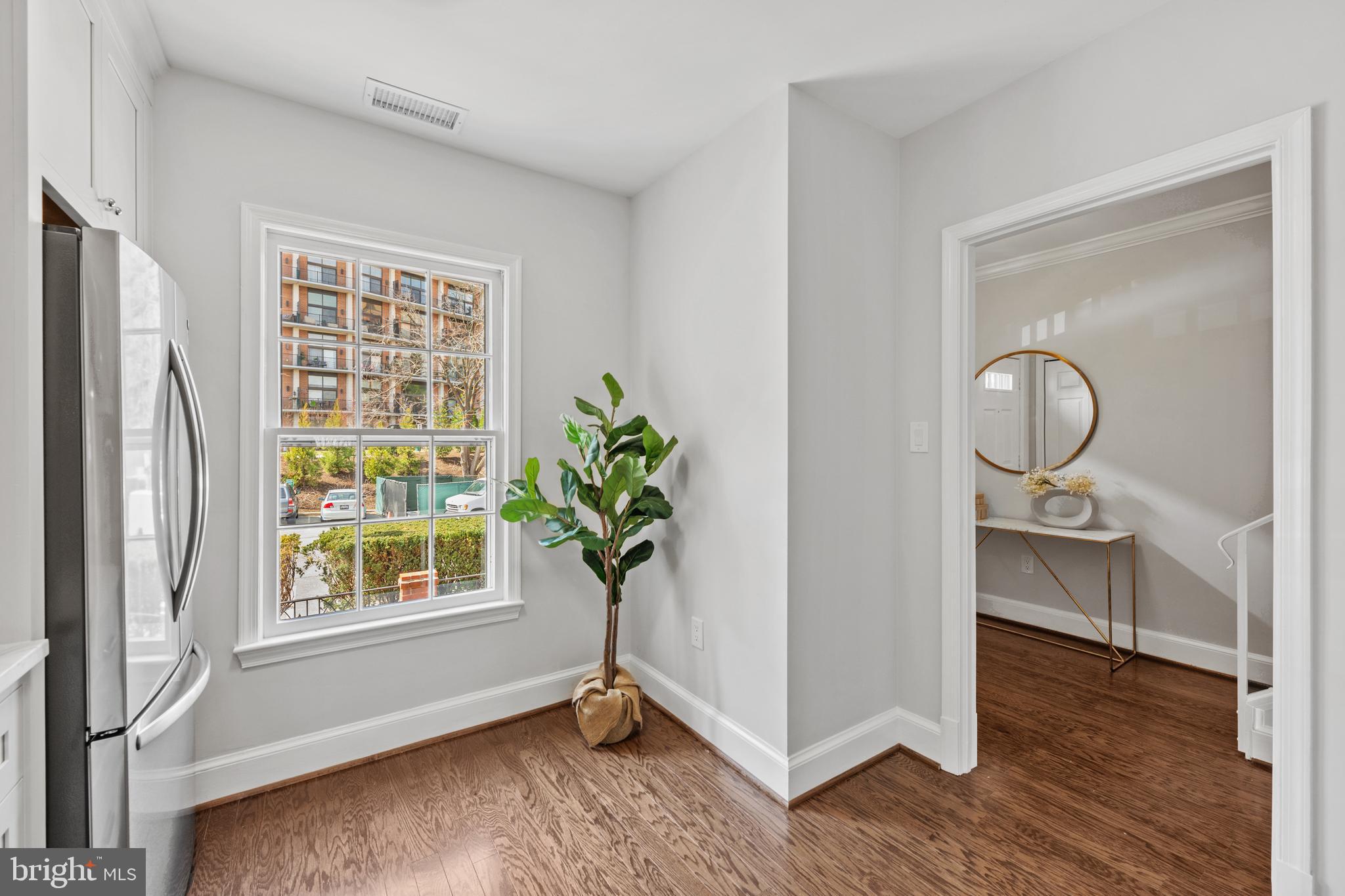 3265 Sutton Place Northwest, Unit B Washington, DC 20016 - Photo 12 of 45 a view of an empty room with wooden floor and a window