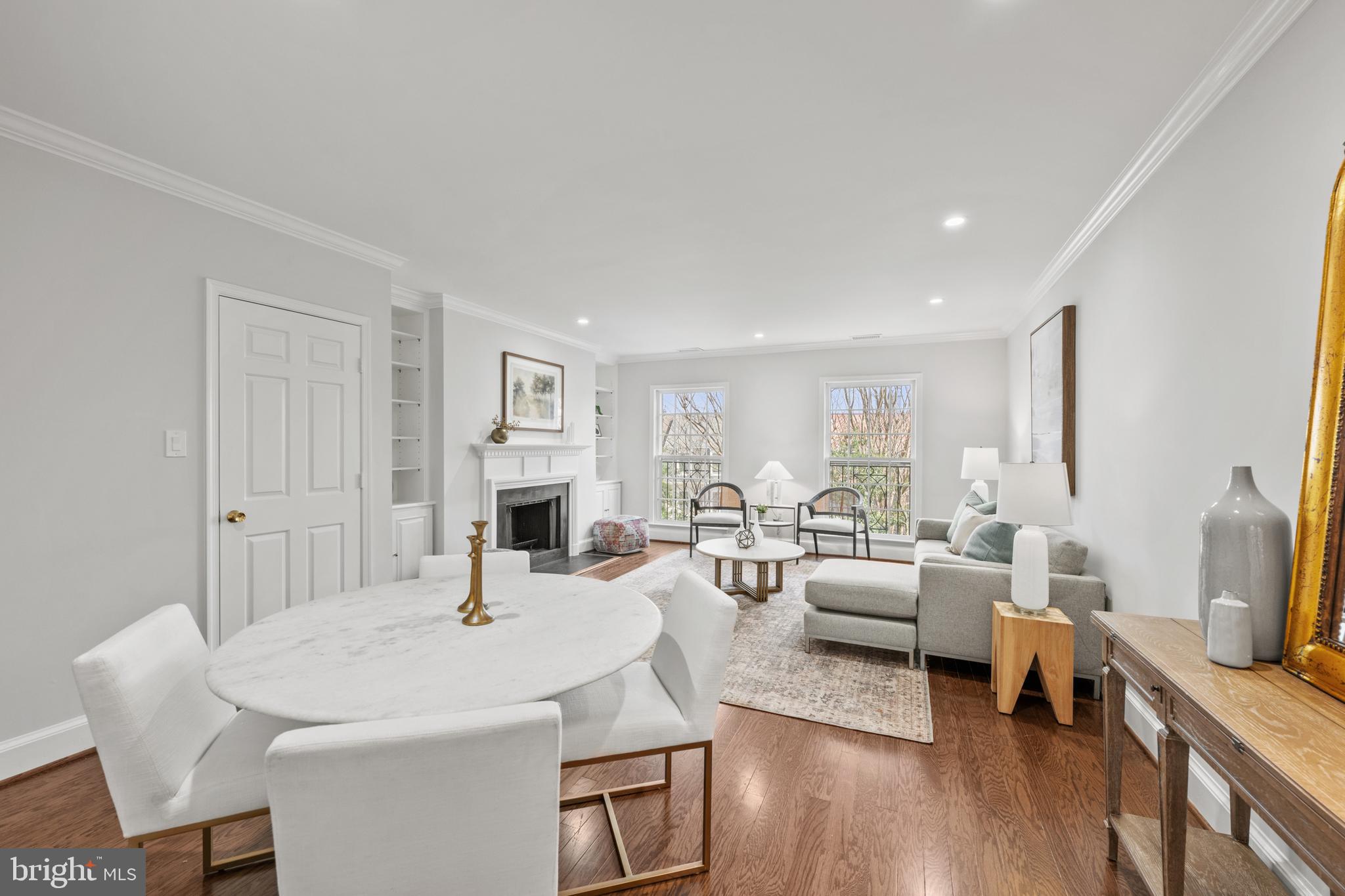 3265 Sutton Place Northwest, Unit B Washington, DC 20016 - Photo 14 of 45 a living room with furniture a fireplace and a flat screen tv
