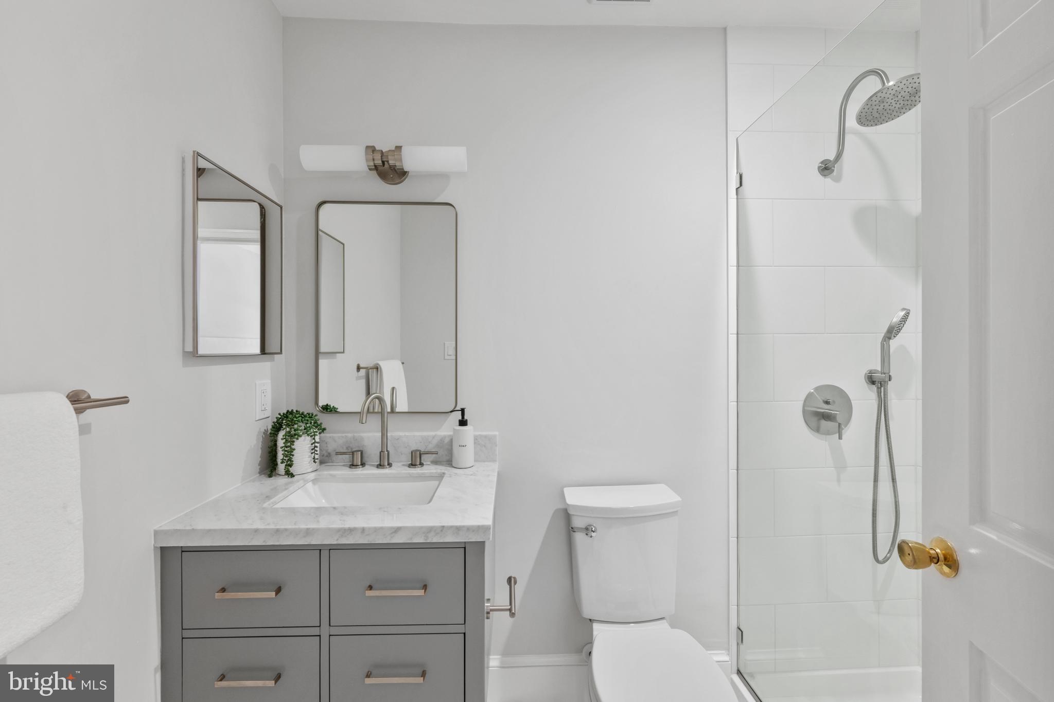 3265 Sutton Place Northwest, Unit B Washington, DC 20016 - Photo 29 of 45 a bathroom with a granite countertop sink a toilet and shower