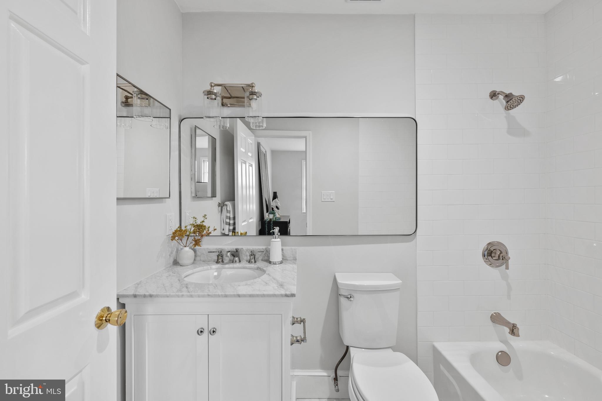 3265 Sutton Place Northwest, Unit B Washington, DC 20016 - Photo 34 of 45 a bathroom with a sink a toilet and shower