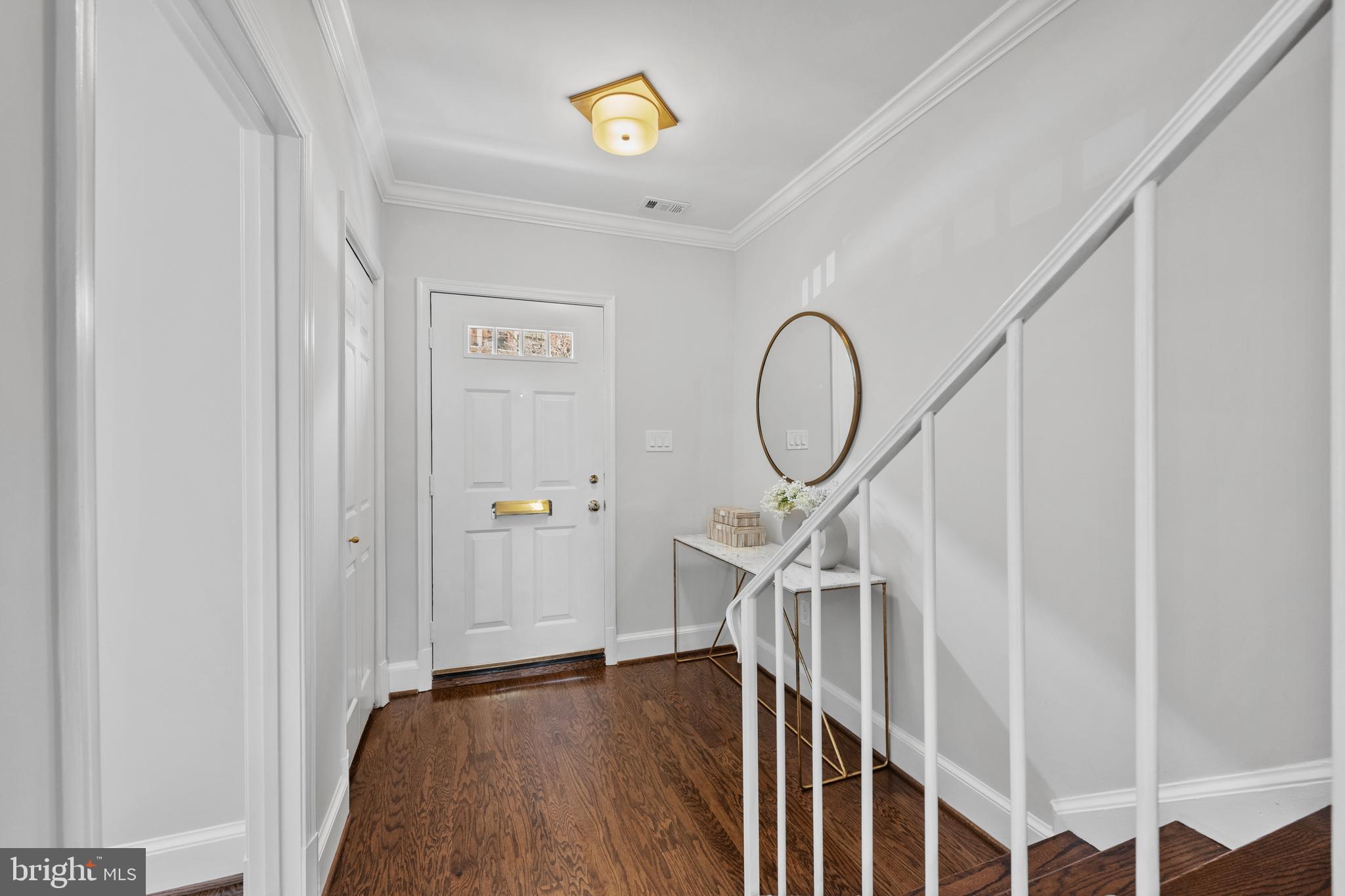 3265 Sutton Place Northwest, Unit B Washington, DC 20016 - Photo 5 of 45 a view of staircase with railing and a chandelier