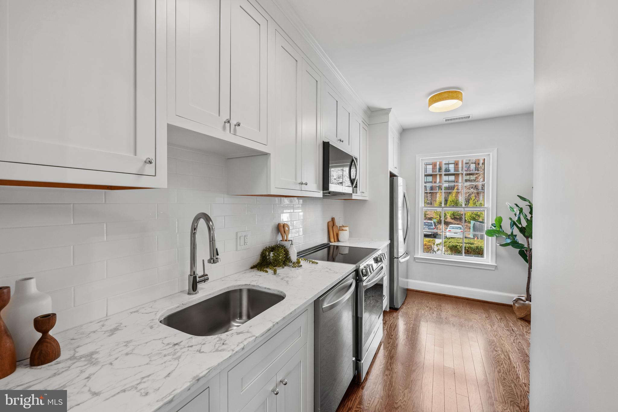 3265 Sutton Place Northwest, Unit B Washington, DC 20016 - Photo 10 of 45 a kitchen with a sink cabinets and window
