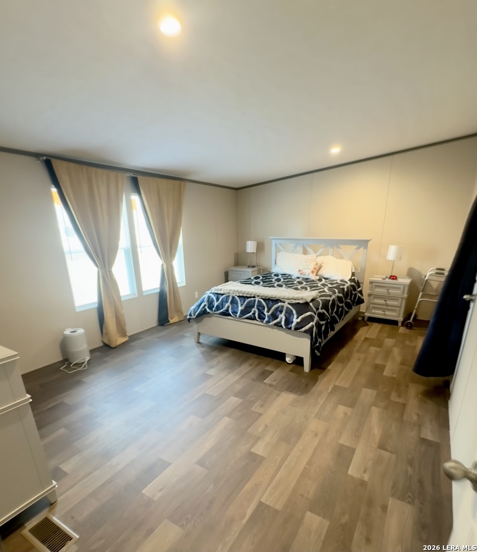 4858 Stanislaus Adkins, TX 78101 - Photo 10 of 19 a spacious bedroom with a bed and a large window