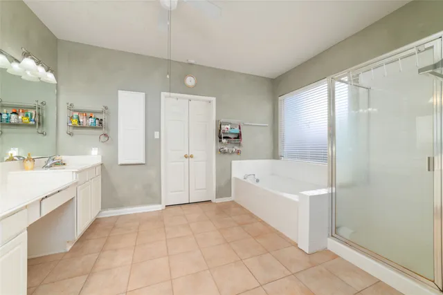 a spacious bathroom with a tub shower and sink