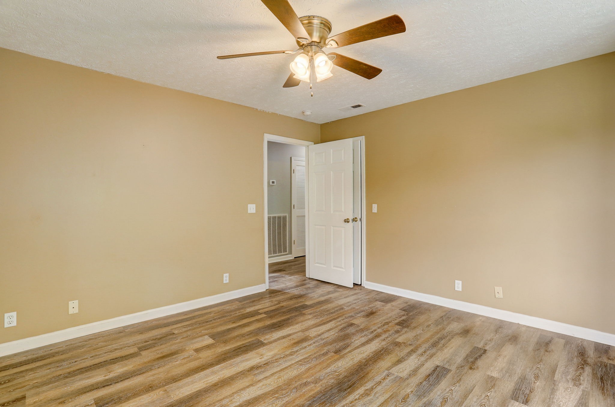 308 Ranch Road Portland, TN 37148 - Photo 22 of 43 a view of a big room with wooden floor and a ceiling fan