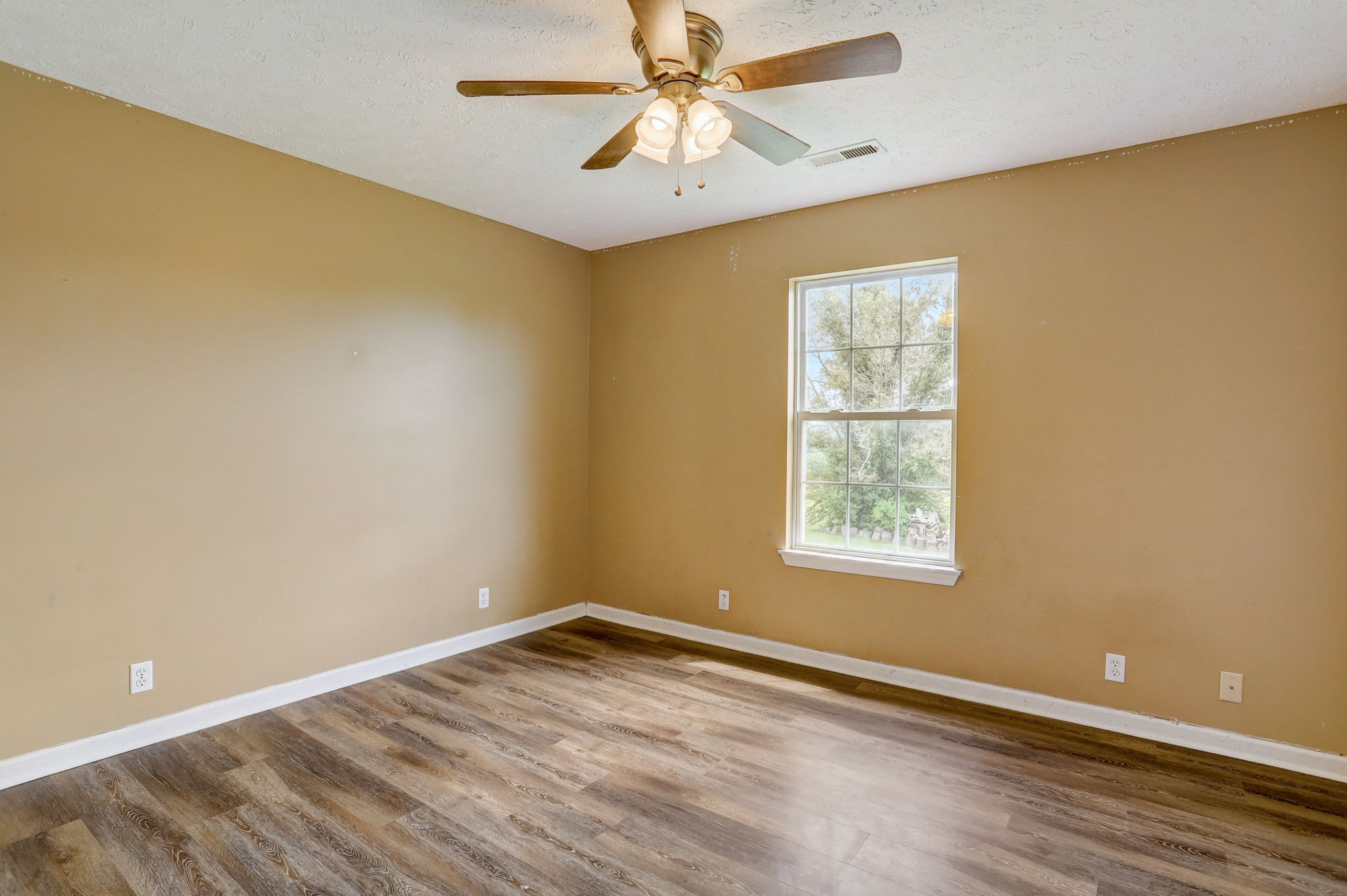 308 Ranch Road Portland, TN 37148 - Photo 23 of 43 an empty room with a window and a ceiling fan