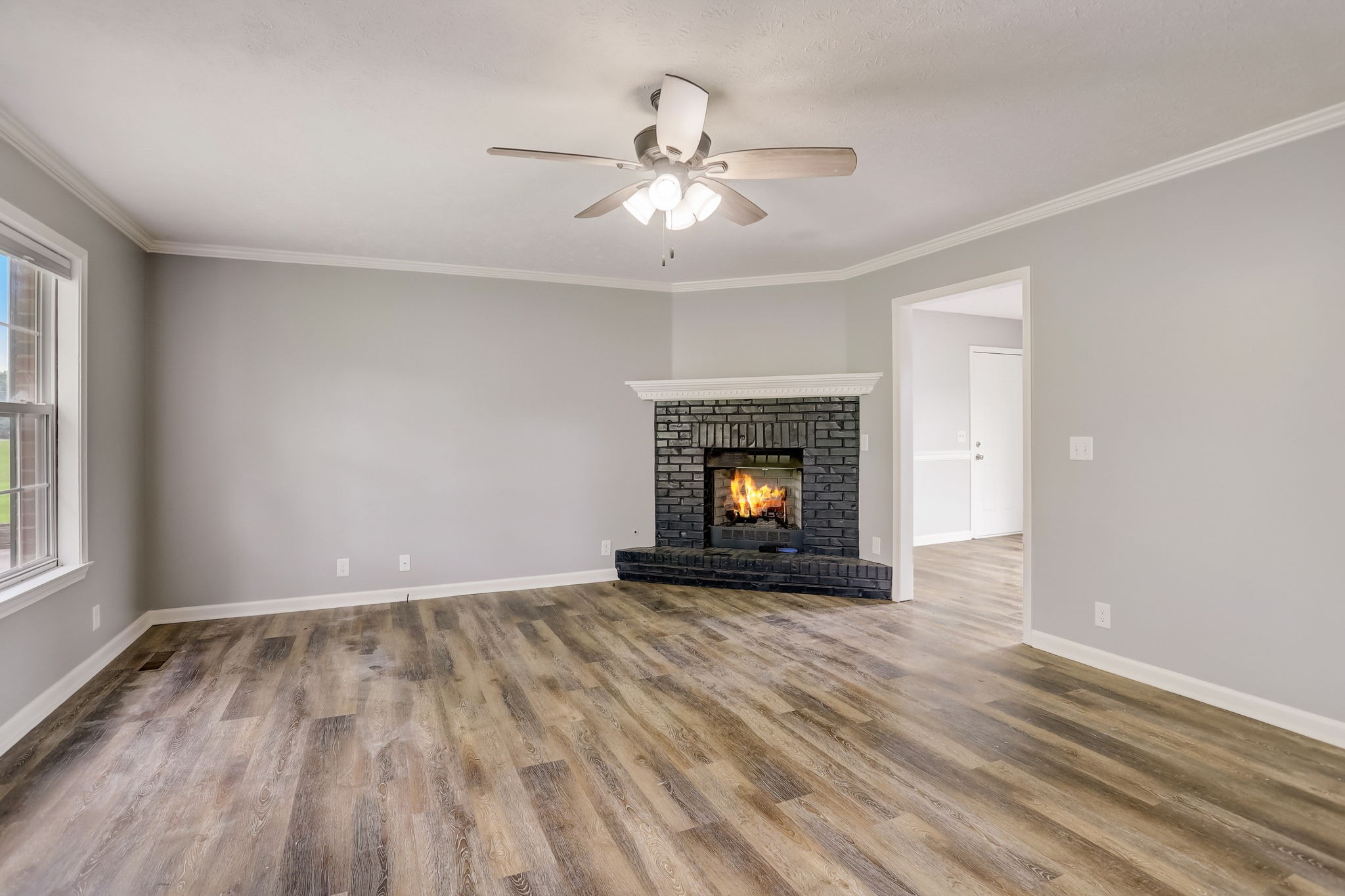 308 Ranch Road Portland, TN 37148 - Photo 5 of 43 a view of an empty room with wooden floor fireplace and a window