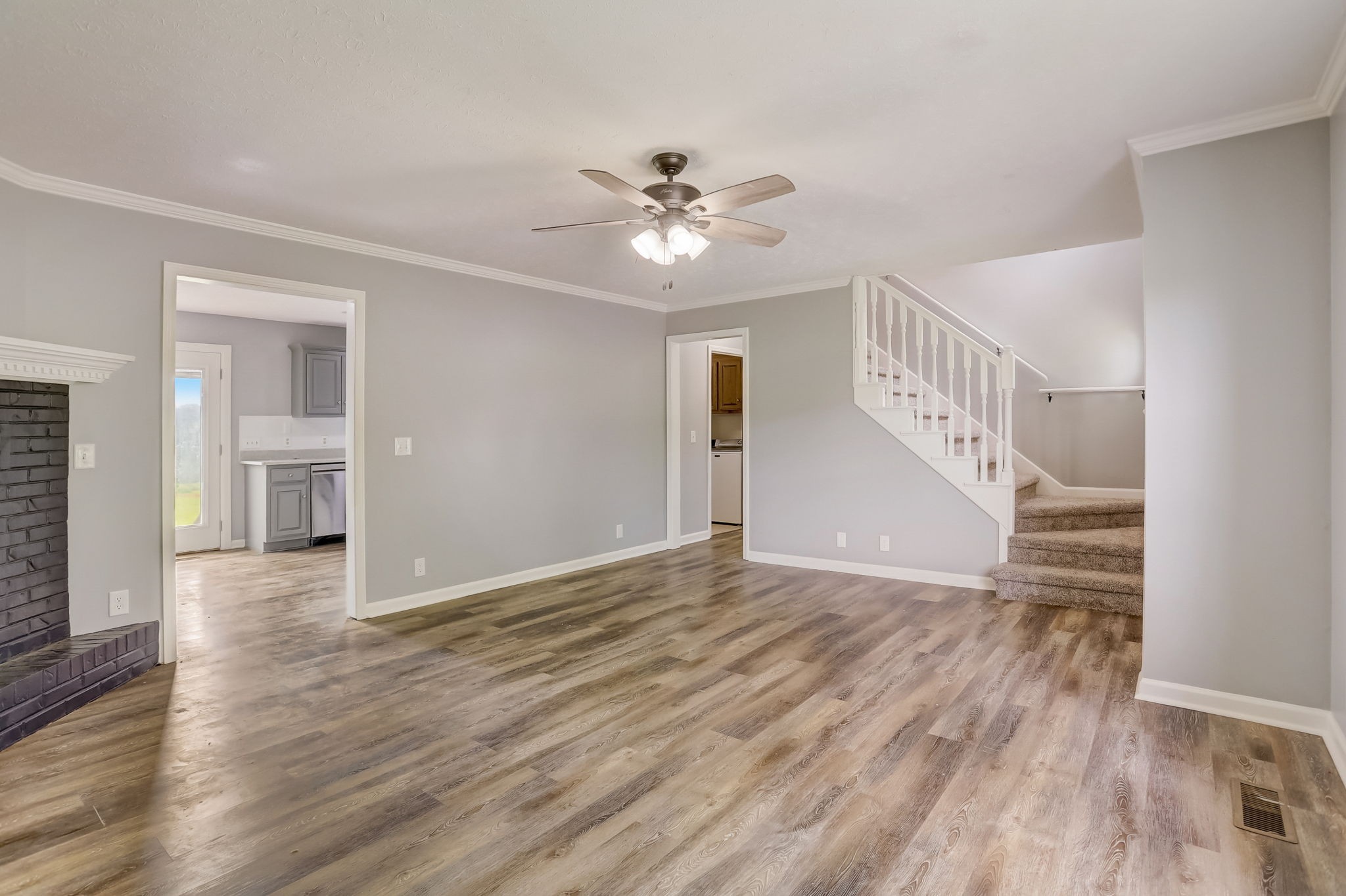 308 Ranch Road Portland, TN 37148 - Photo 6 of 43 a view of an empty room with wooden floor and a ceiling fan