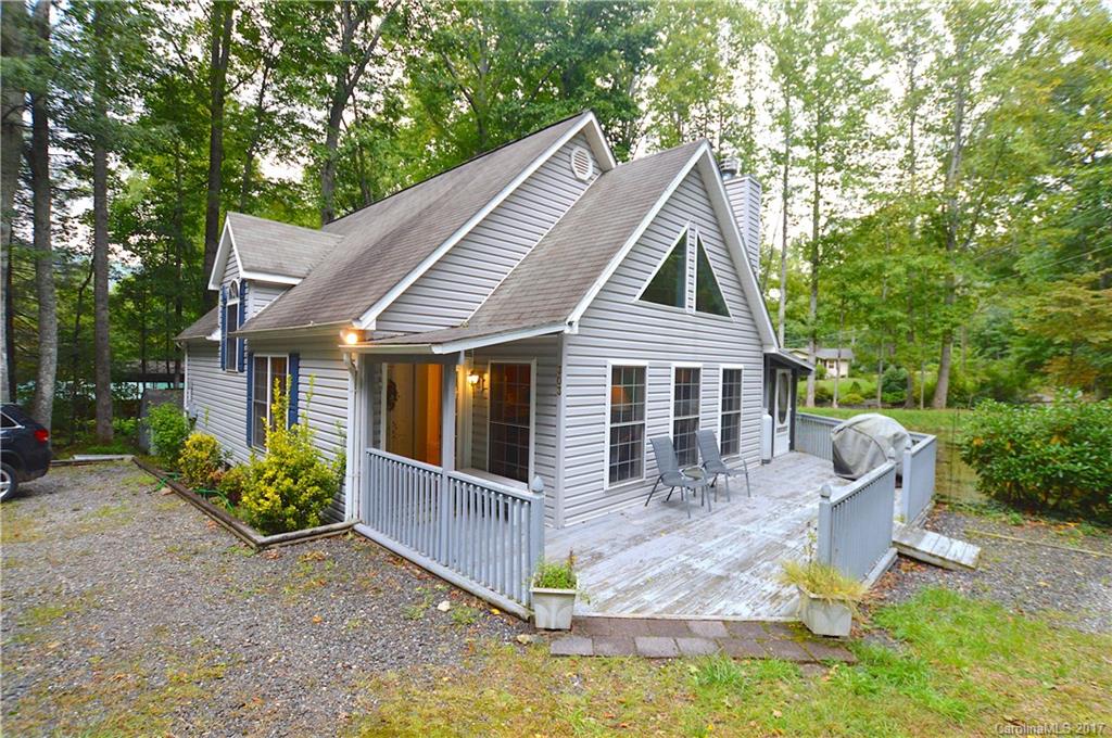 303 Spring Lake Road Maggie Valley, NC 28751 - Photo 1 of 25 a front view of a house with garden
